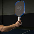 man's arm and hand holding a FLiK F1 USAP approved pickleball paddle